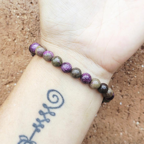 Atlantisite crystal bracelet worn on wrist, handmade design promoting balance and emotional healing.