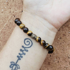 Tiger’s Eye gemstone bracelet aligning the sacral and solar plexus chakras.