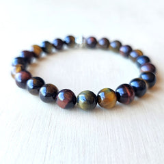 Handmade Tiger’s Eye Trio bracelet uniting red, brown, and blue stones for chakra balance.