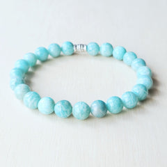 Amazonite gemstone bracelet featuring natural bead variations, designed to open the heart and throat chakras.