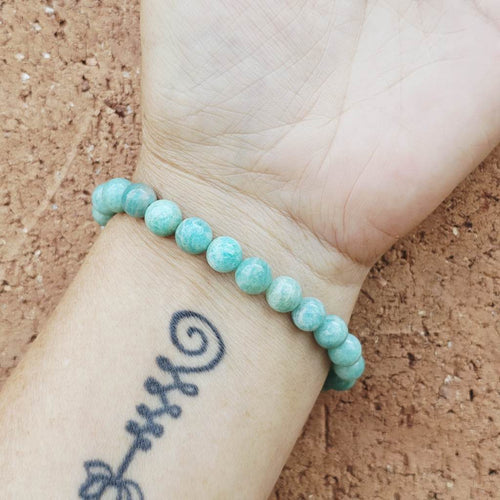 Amazonite crystal bracelet worn on wrist, showing natural colour tones and gentle healing energy.