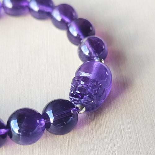 Close-up of Amethyst Pixiu bracelet showing detailed carving and rich purple hues.
