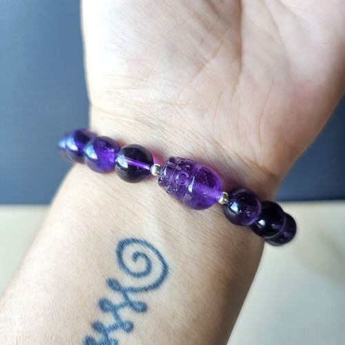 Amethyst Pixiu crystal bracelet worn on wrist, showing intricate Pixiu charm and gemstone shine.