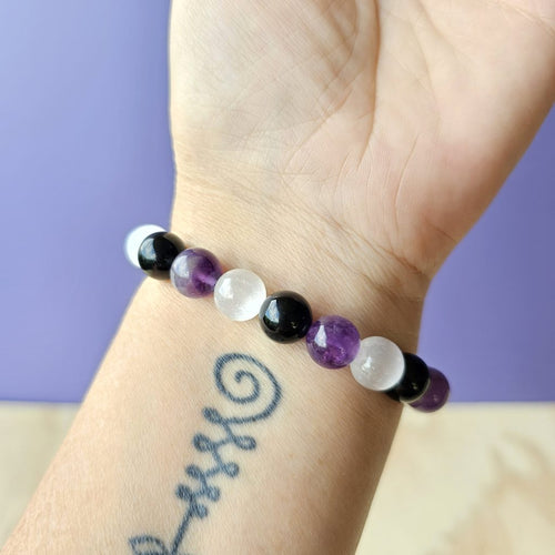 Amethyst, Selenite & Smoky Quartz bracelet worn on wrist, handmade with intention for balance and protection.