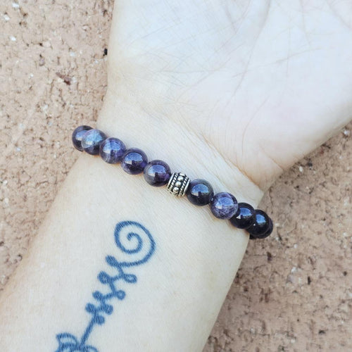 Spiritual energy bracelet combining Amethyst and Smoky Quartz for calm focus.