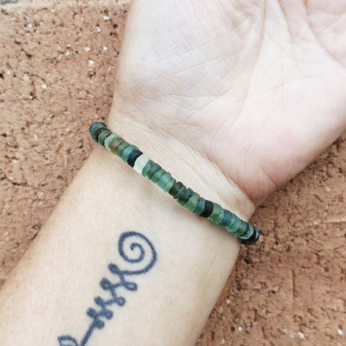 Ancient Roman Glass bracelet worn on wrist, understated luxury with quiet historical beauty.
