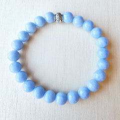 Close-up of Angelite bracelet showing soft blue 8 mm beads sourced from Peru.