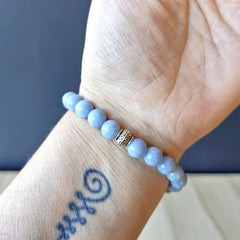 Angelite bracelet on arm, natural gemstone jewellery for peace and higher guidance.