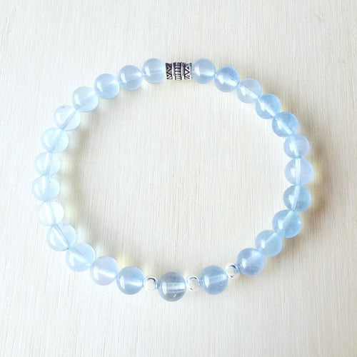 Close-up of Aquamarine bracelet showing soft blue 6 mm beads with sterling silver accents.