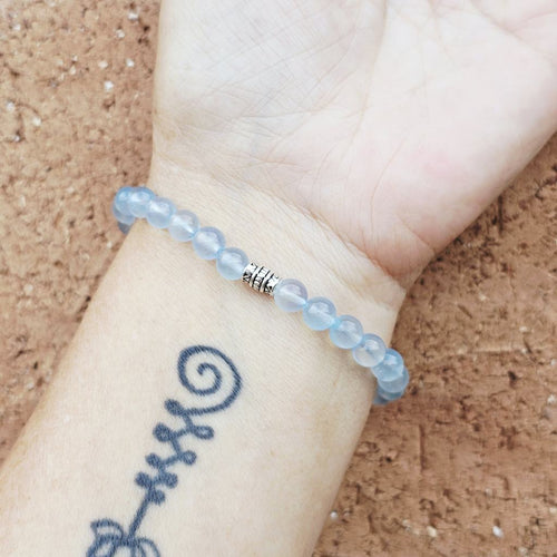 Aquamarine bracelet on arm, refined natural gemstone jewellery inspired by the sea.