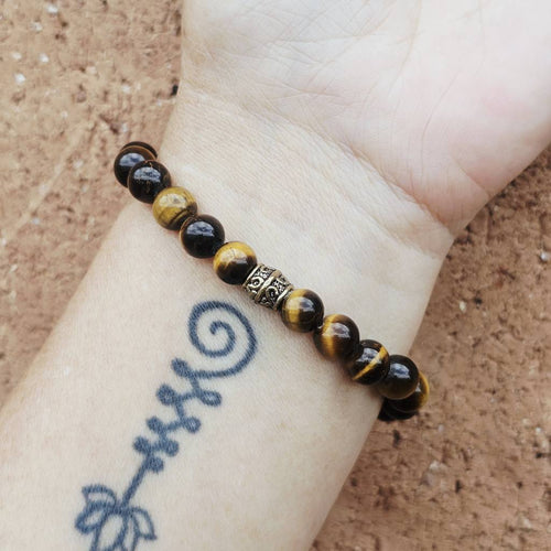 Tiger’s Eye gemstone bracelet aligning the sacral and solar plexus chakras.