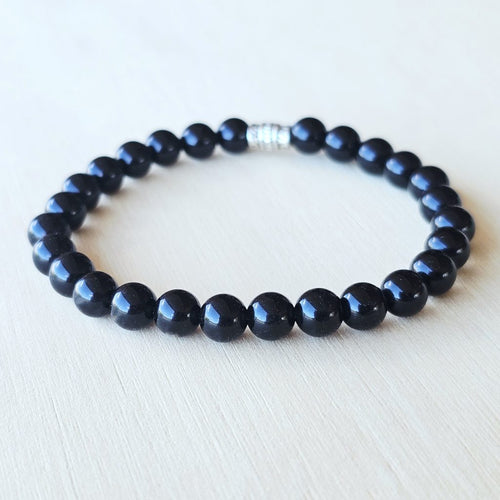 Black Obsidian bracelet aligning the Base Chakra for strength and stability.