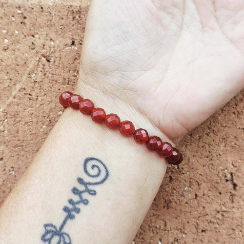 Faceted Carnelian bracelet on wrist, natural stone jewellery for confidence and strength.