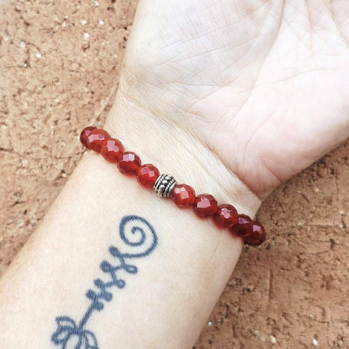 Carnelian crystal bracelet on arm, beaded bracelet for focus, courage and drive.