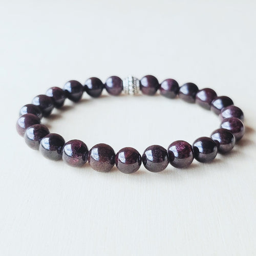 Garnet stone bracelet balancing Root and Heart Chakras for stability.