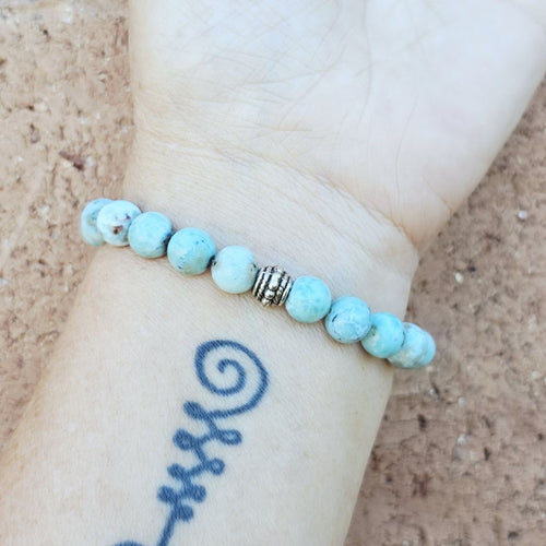 Larimar crystal bracelet with soft blue tones promoting serenity and healing.