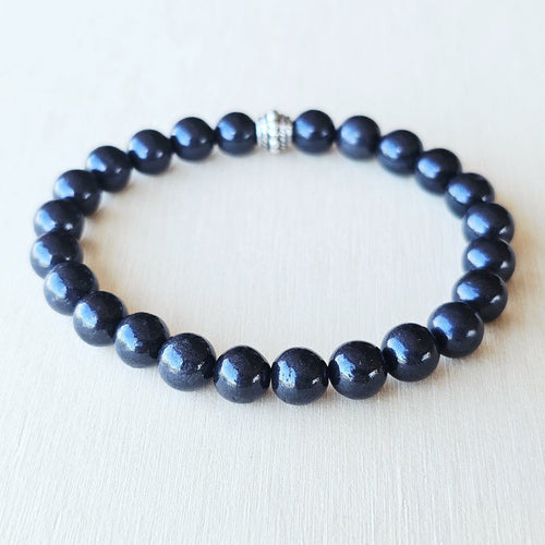 Black gemstone bracelet connecting to the Root Chakra.