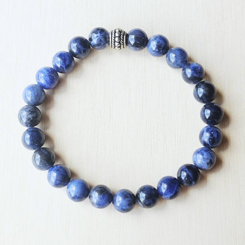 Blue gemstone bracelet activating the Throat and Third Eye Chakras.