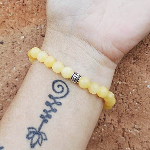 Yellow beaded bracelet on a wrist 