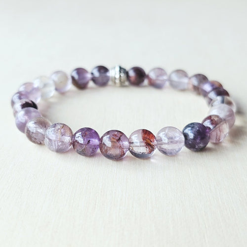 Rare seven-mineral Super 7 bracelet showcasing inclusions of rutile, lepidocrocite, cacoxenite.