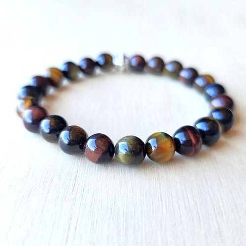 Handmade Tiger’s Eye Trio bracelet uniting red, brown, and blue stones for chakra balance.
